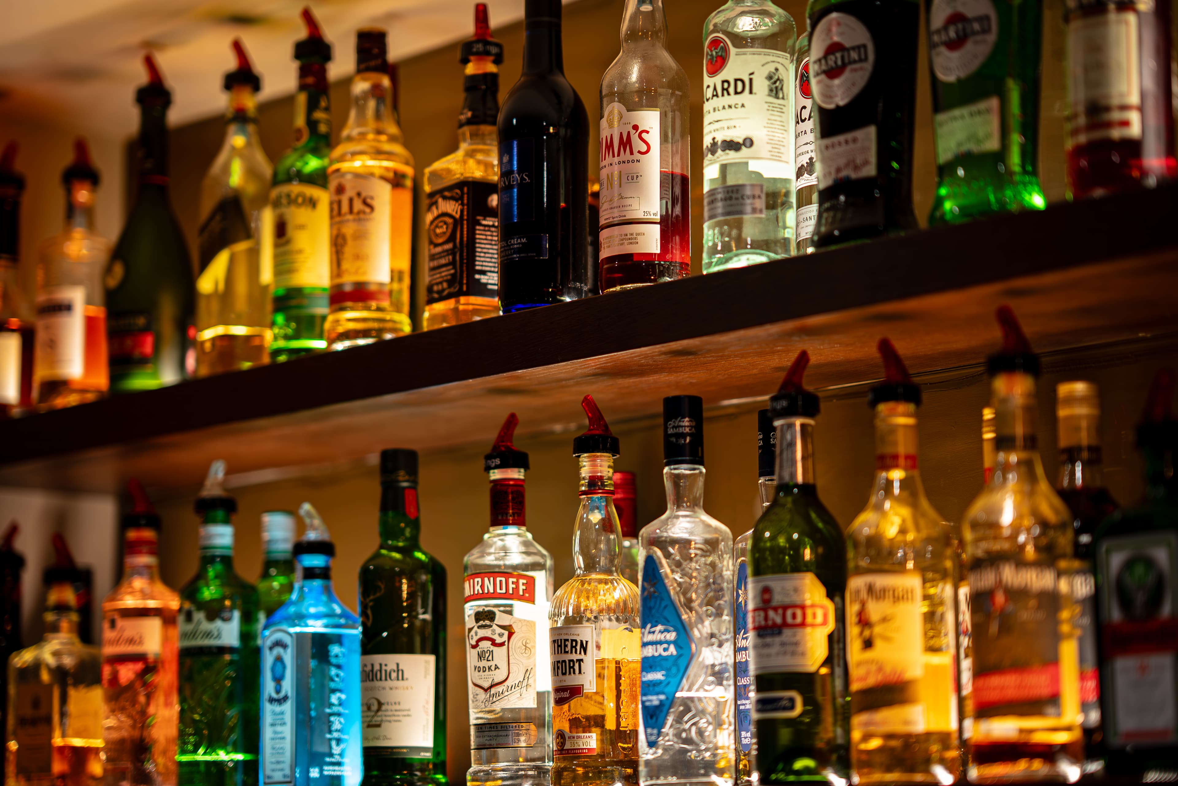 Well-stocked bar shelf with spirits and liqueurs