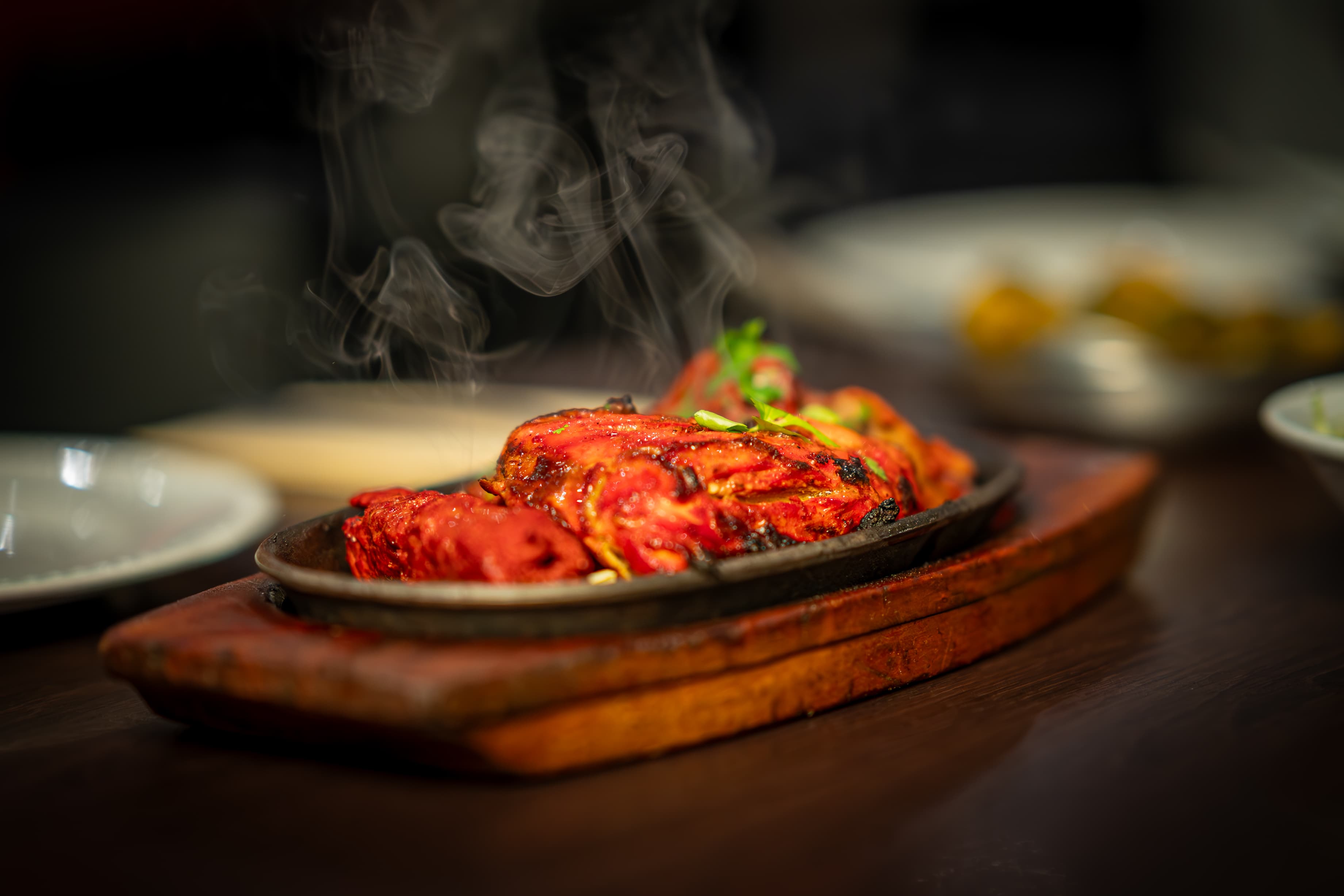 Sizzling tandoori platter with steam rising