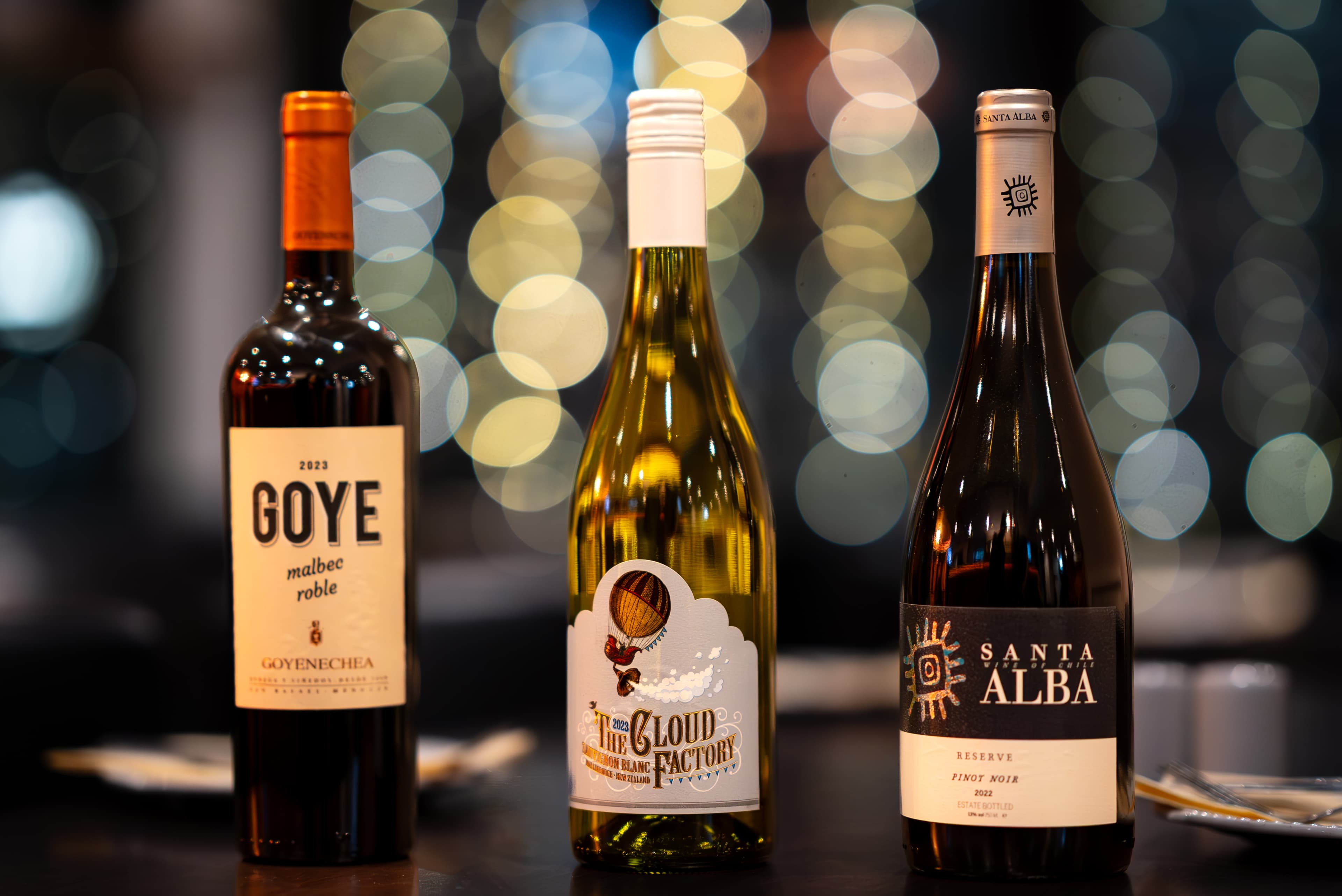 Three wine bottles on a restaurant table